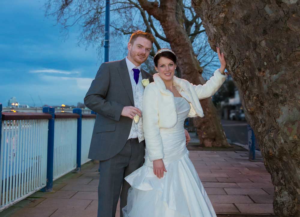wedding couple stood by Thames photo