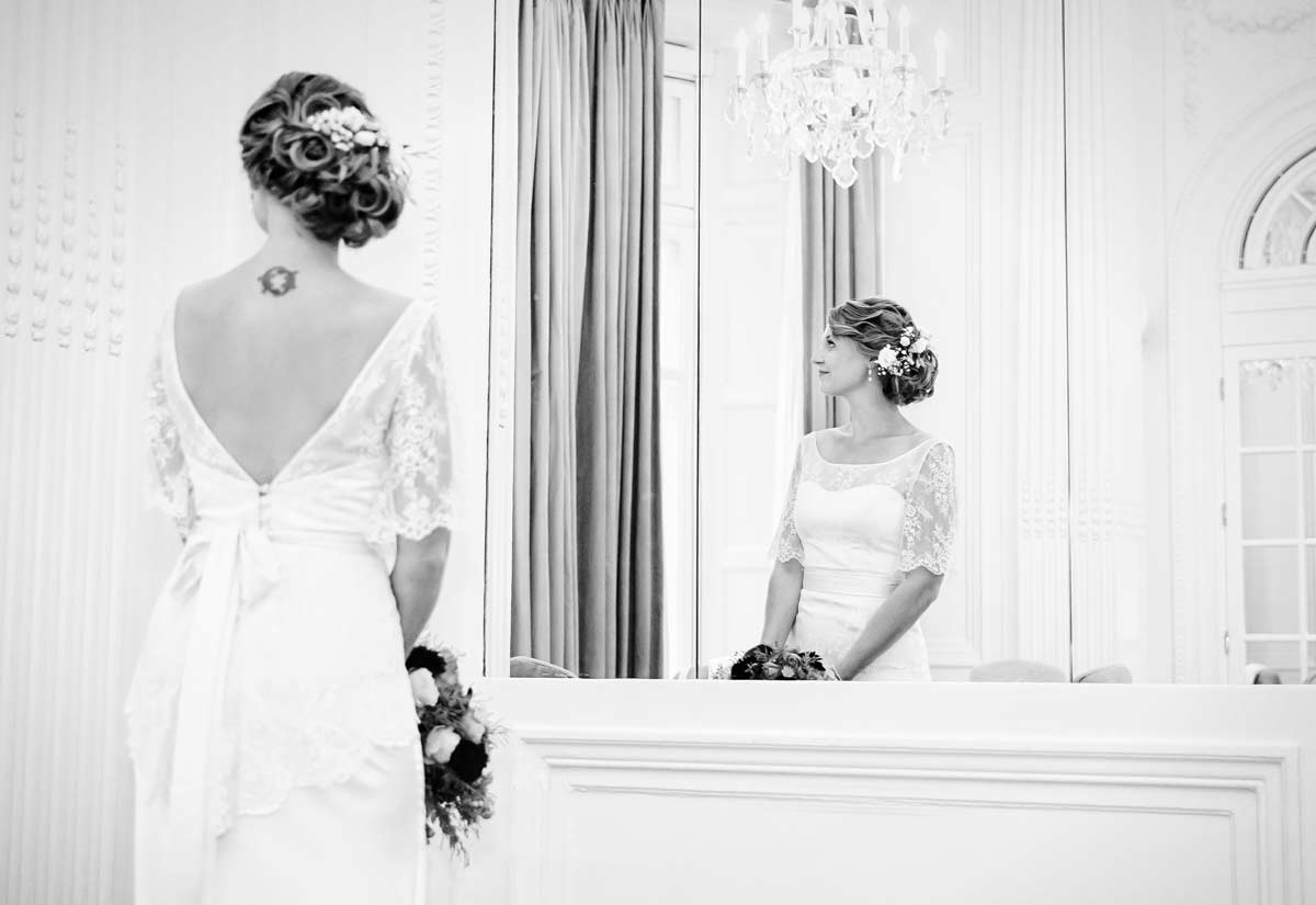 Bride looks through window at Mandarin Oriental Hotel