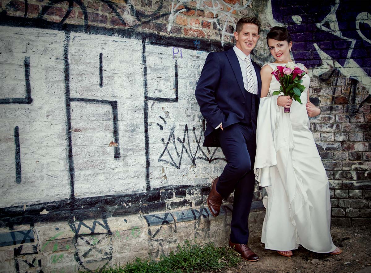 couple by graffiti in Camden on their wedding day image