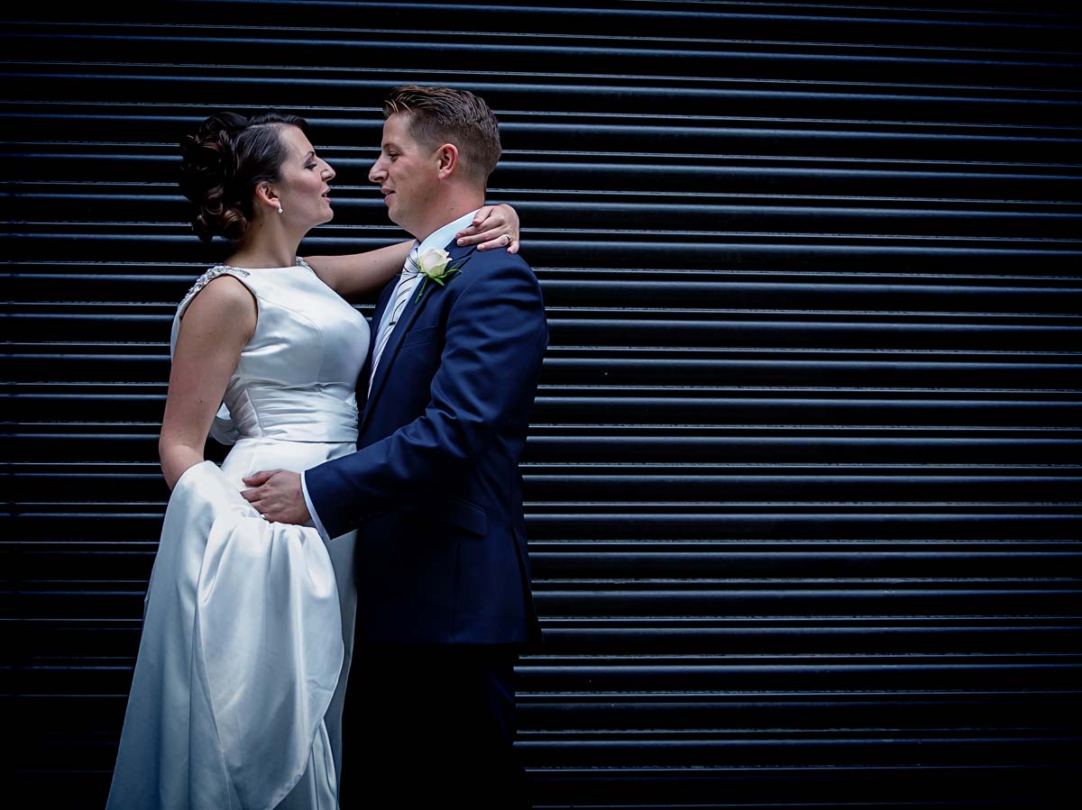 newly weds in front of London roller doors Camden
