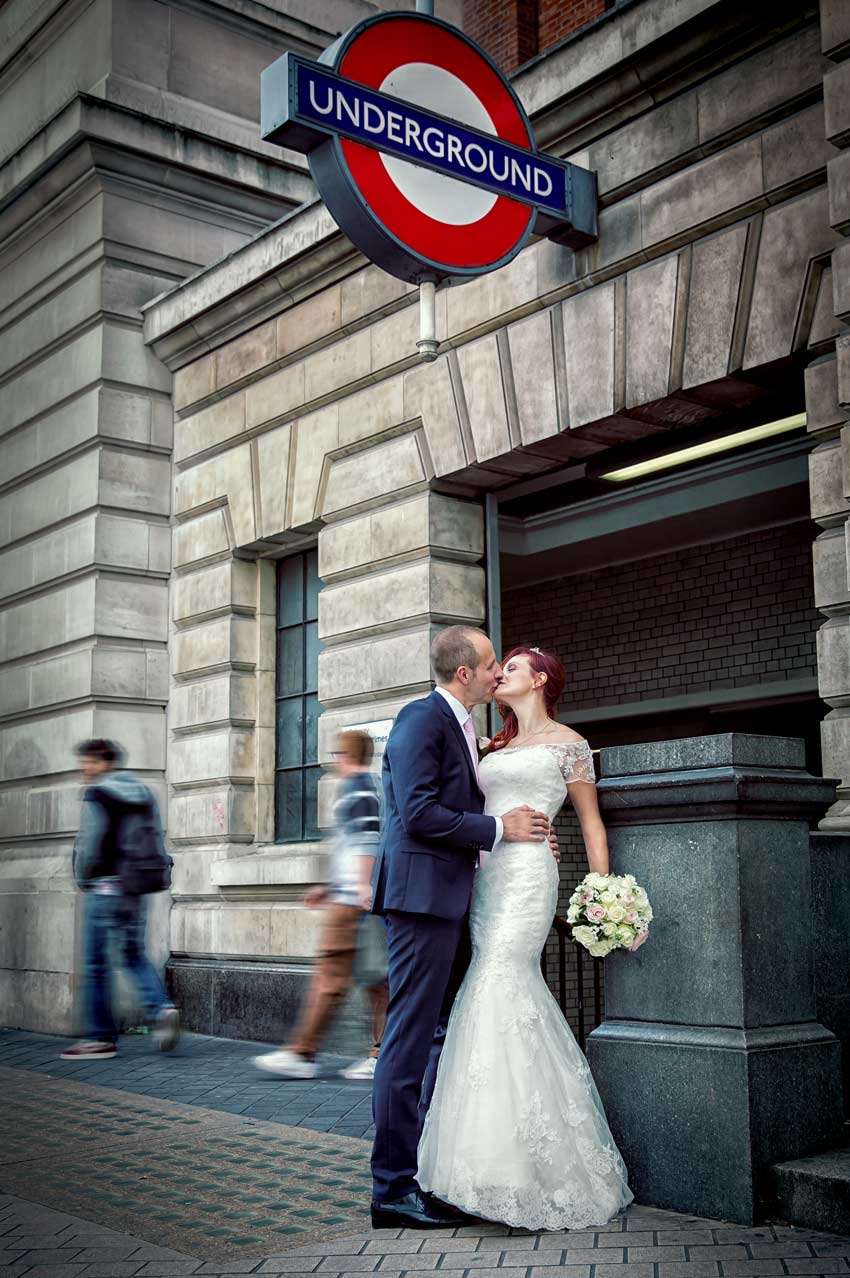 Kissing after wedding outside Kensington tube station