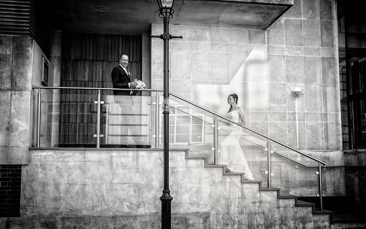 wedding couple pose on steps in London's Kensington