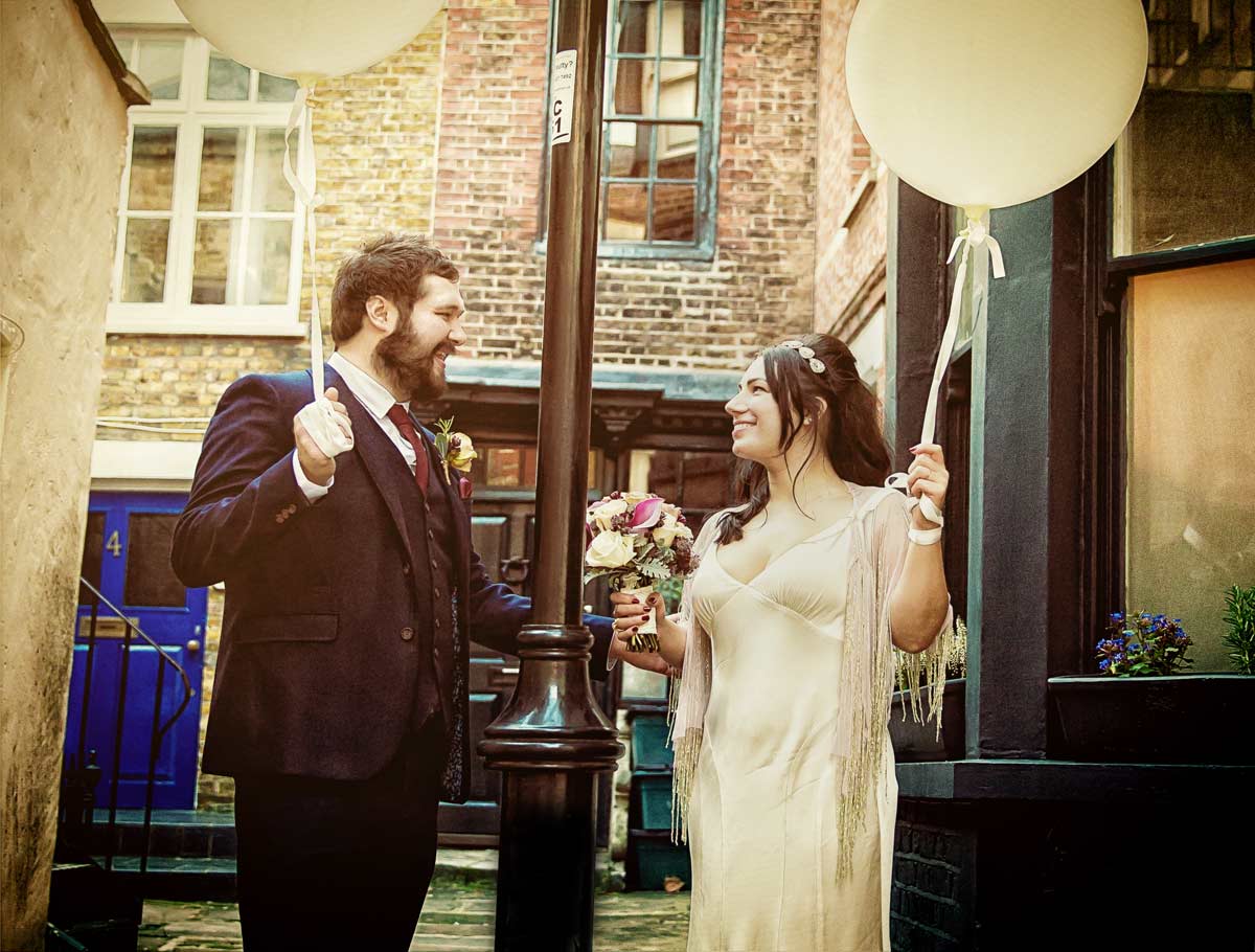 Bride and groom hold wedding balloons Londons Islington borough