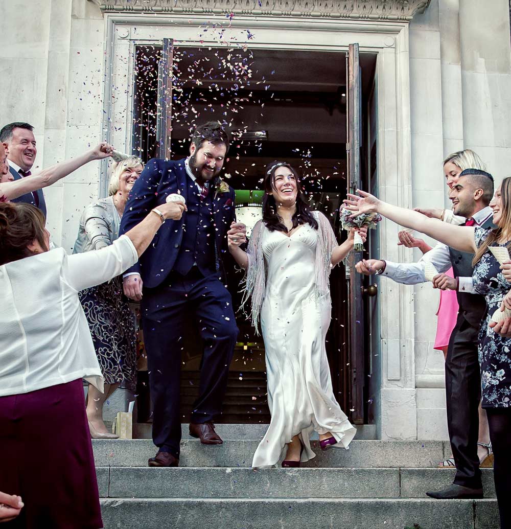 image of wedding party throwing confetti atIslington Town Hall