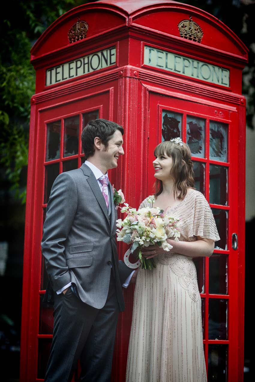 Islington bride and groom by red London phone box