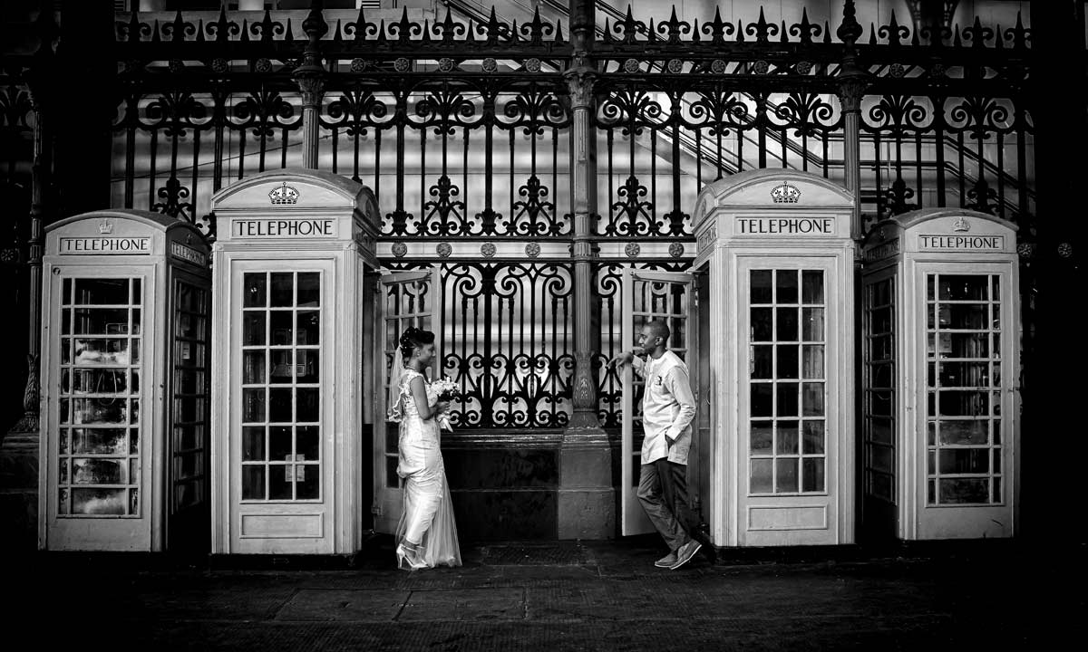 Phone boxes and bride and groom in Smithfield Market London