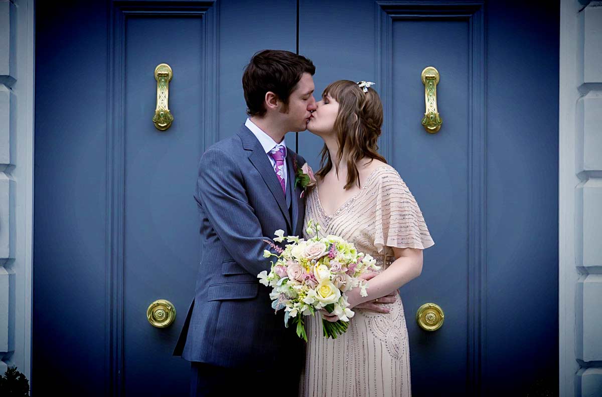 kissing by the blue door Peasant pub Clerkenwell wedding shot