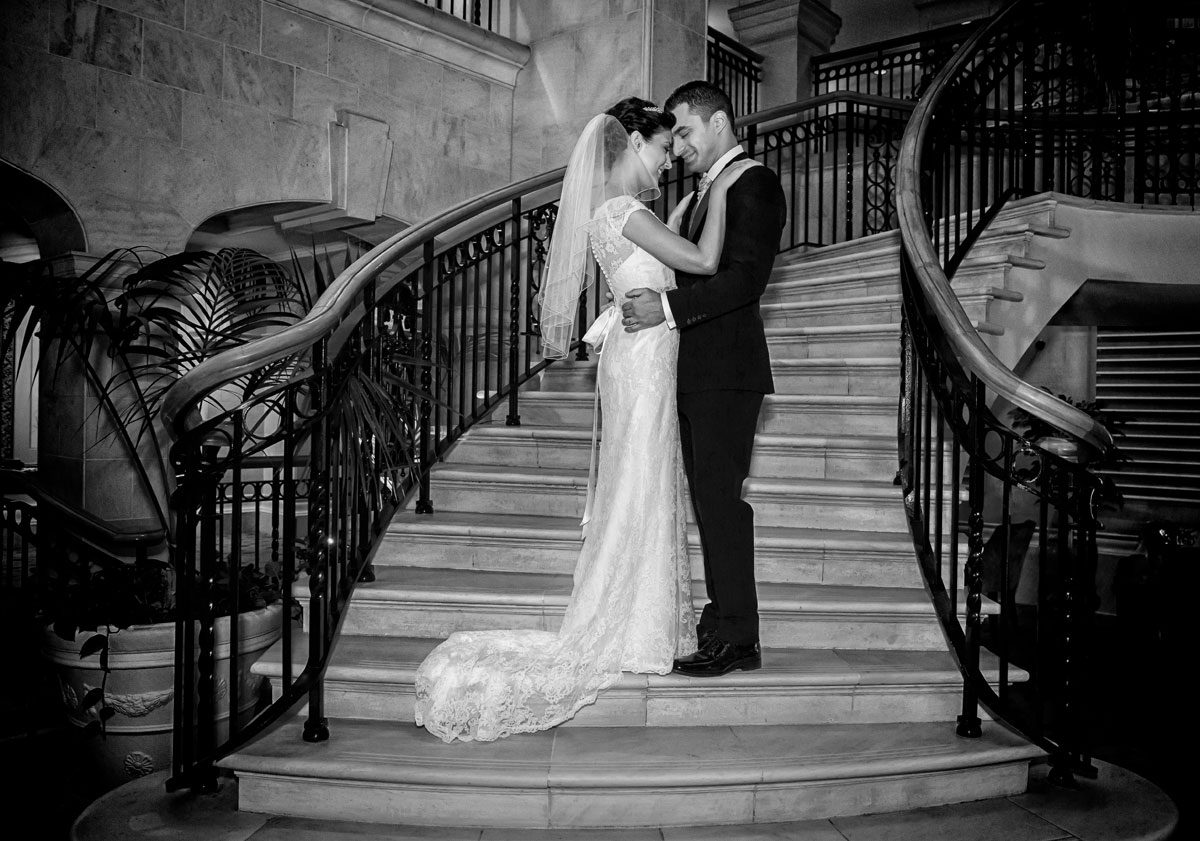 bride and groom hug on Landmark Hotel stairs
