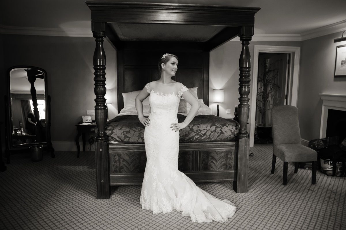 Bride in front of four poster bed Hampton Court wedding shot