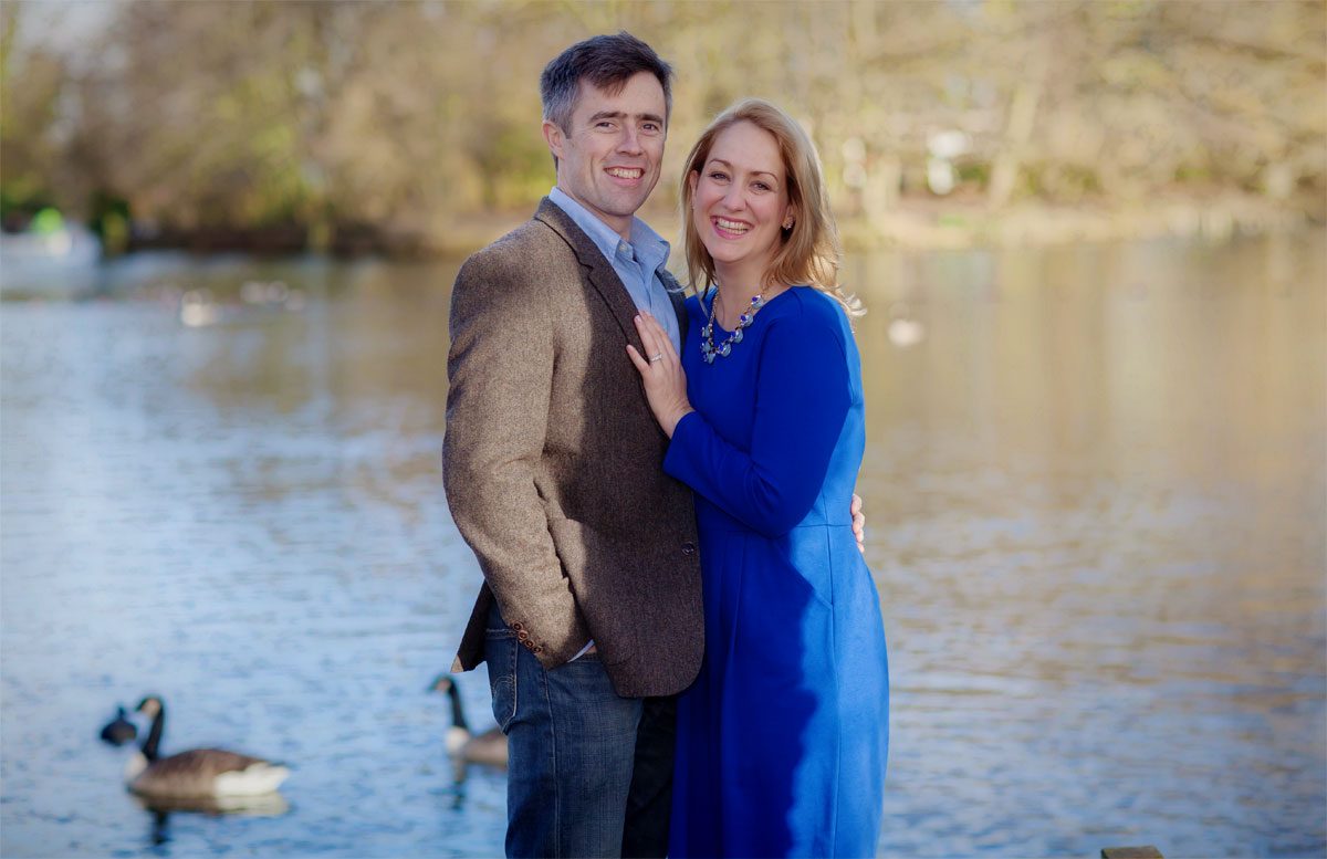 Engagement couple smiling at boating lake
