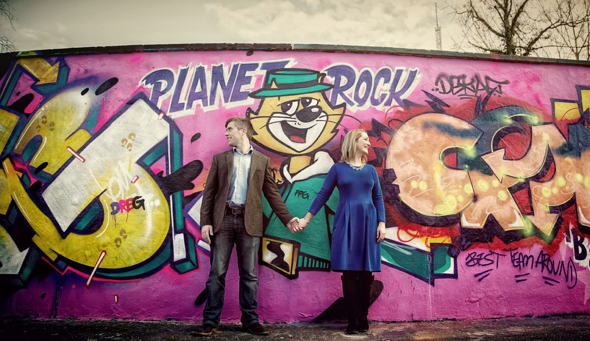 Engagement shoot couple stand by Alexandra Palace grafitti wall