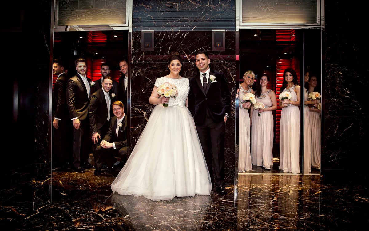 Bridal party pose in lifts Jewish wedding Four Seasons Park Lane London