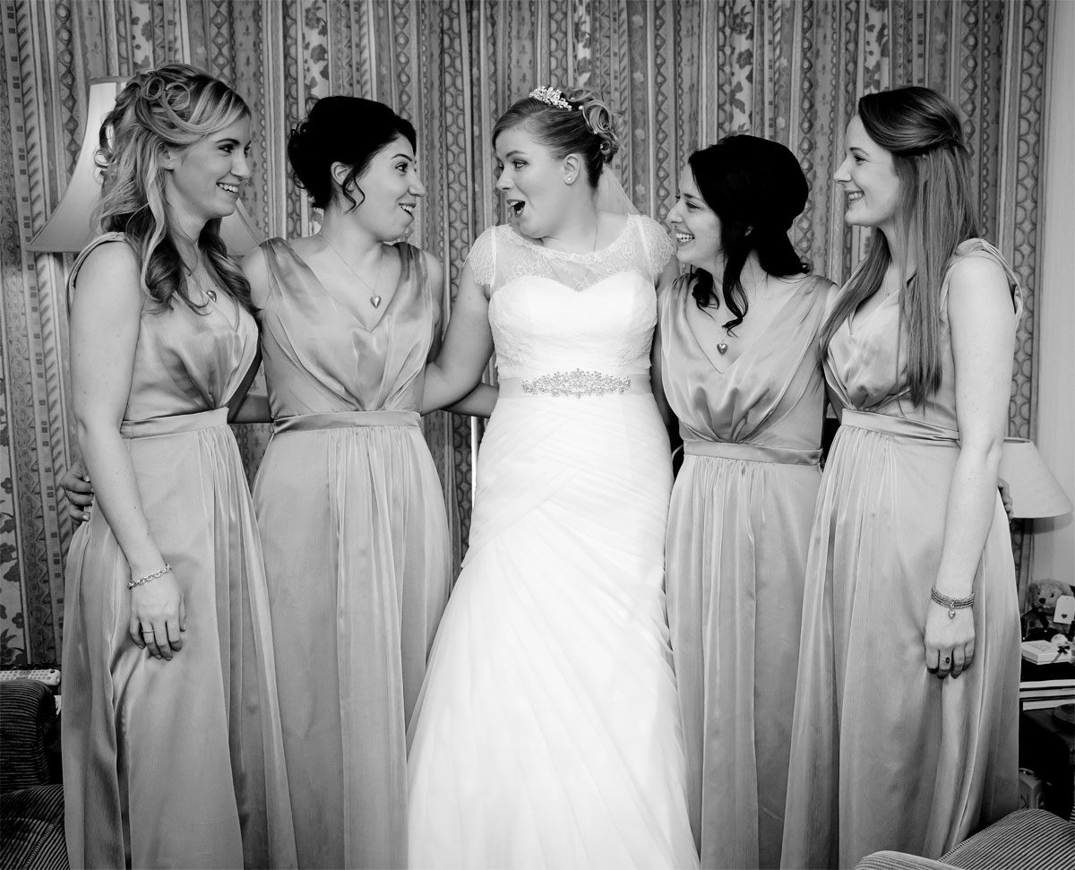 Bride and bridesmaids laugh at London wedding