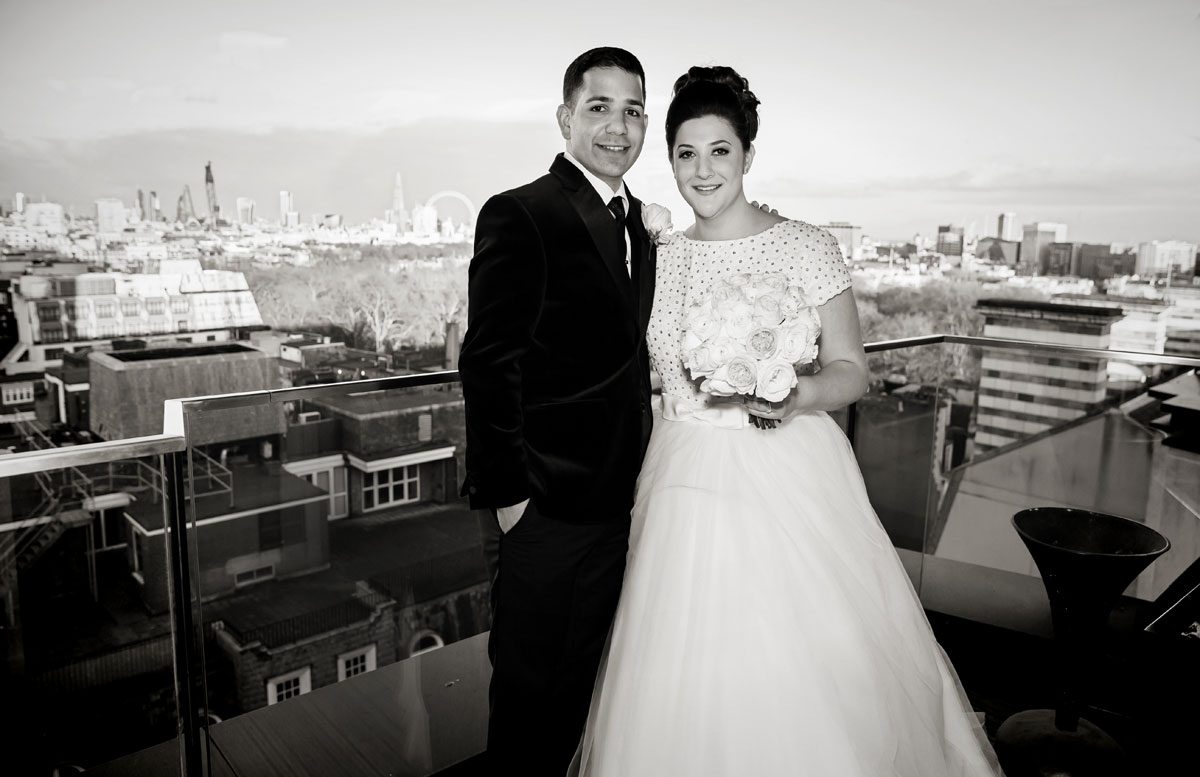 Wedding couple pose on roof Four Seasons Hotel
