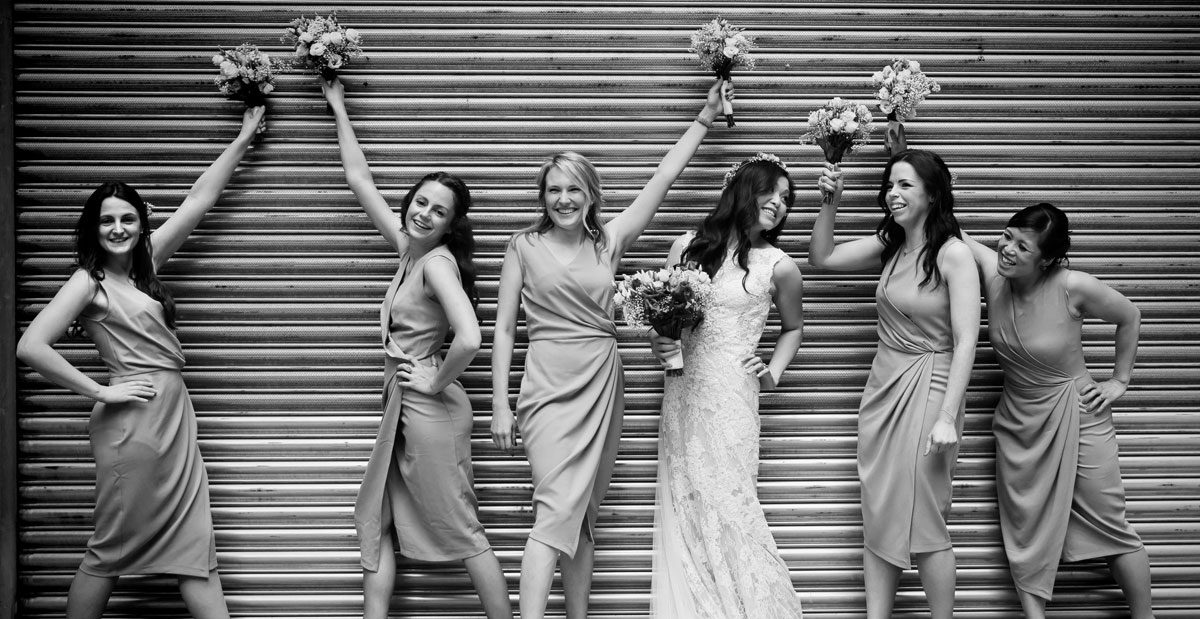 Bridesmaids pose in front of central London roller doors photo