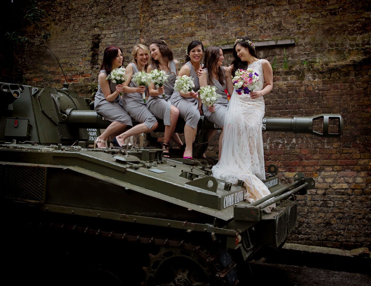 Bridesmaids sit on tank at London Islington wedding day image