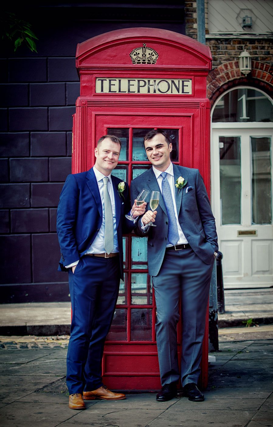 Couple with champagne by Clerkenwell phone box