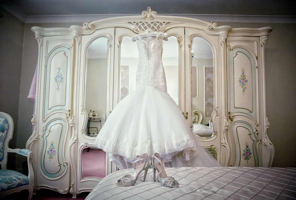 Italian wedding dress and shoes in brides bedroom photo