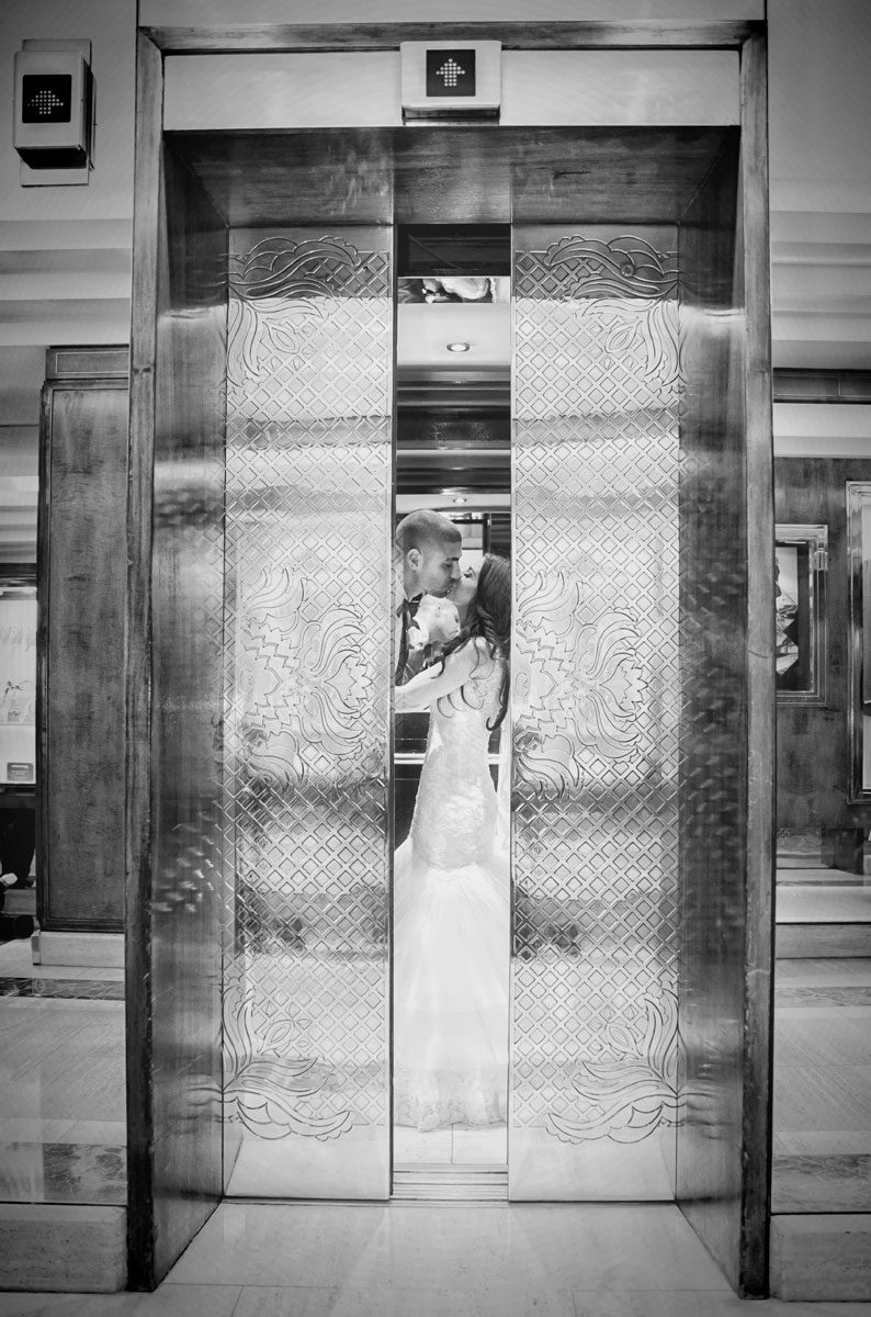 wedding couple kiss in the lift at Jumeriah Carlton Hotel London