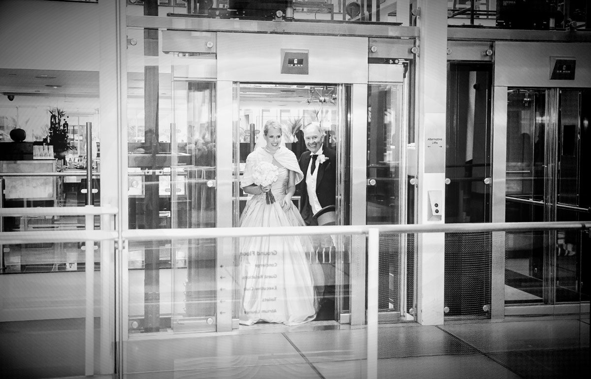 Bride and father in lift on St Pauls wedding day image