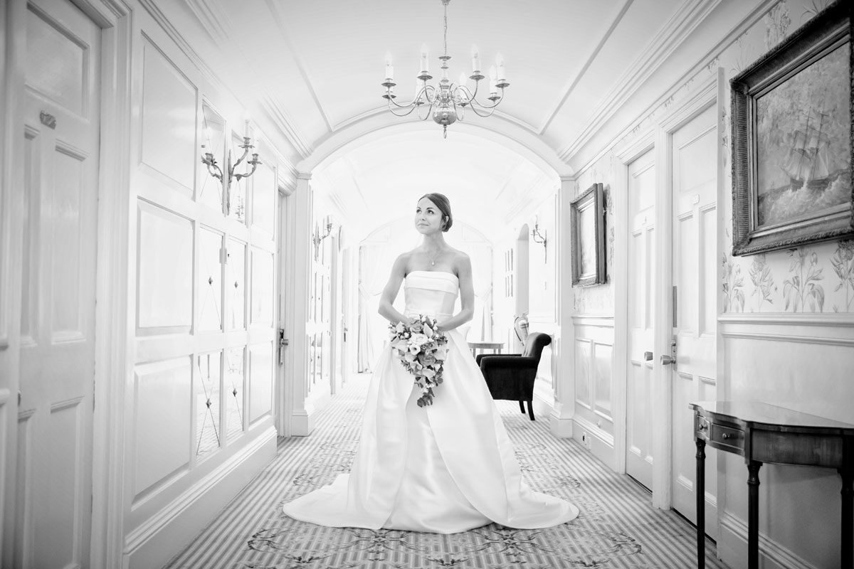 Bride waits in hallway at London Goring Hotel wedding