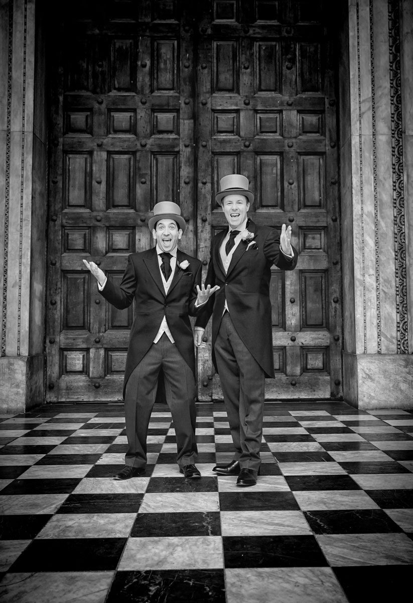 Groom and bestman pose outside St Paul's Cathedral on wedding day