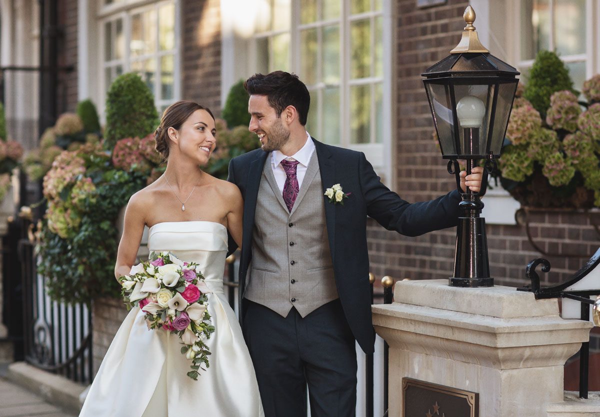 Laughing outside the Goring Hotel on their wedding day image