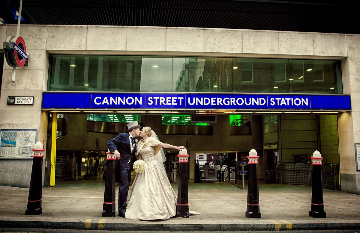 London wedding couple kiss by tube station
