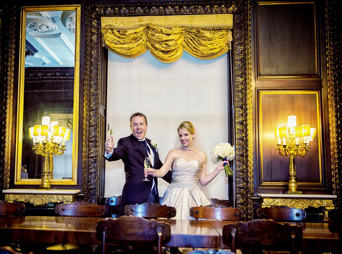 Wedding couple celebrate with champagne in Skinners Hall courtroom image