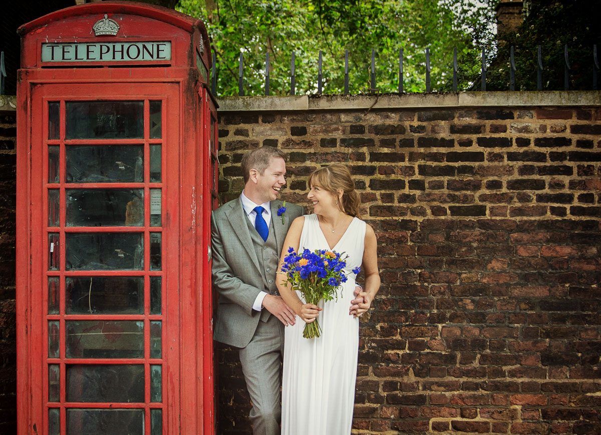 Shoreditch wedding couple by red London phone box photo