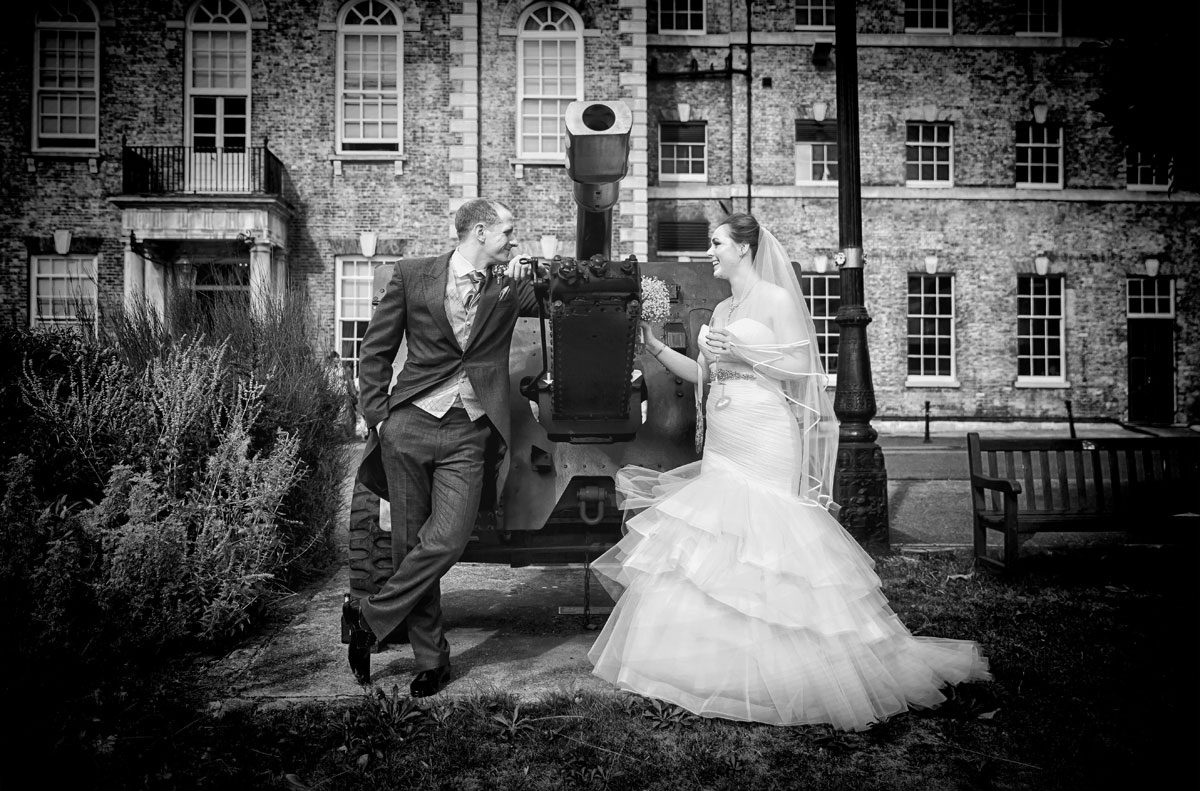 Wedding couple pose by gun at HAC Armoury House wedding
