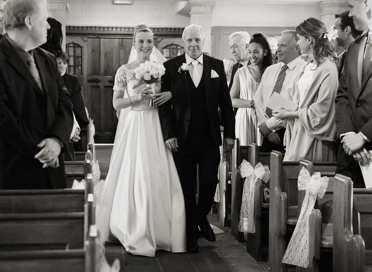 Bride-and-her-father-walk-down-the-aisle-for-church-wedding