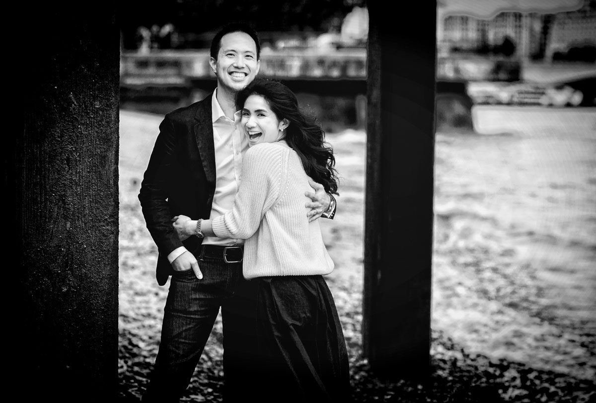 Couple laugh on beach for London Southbank engagement shoot