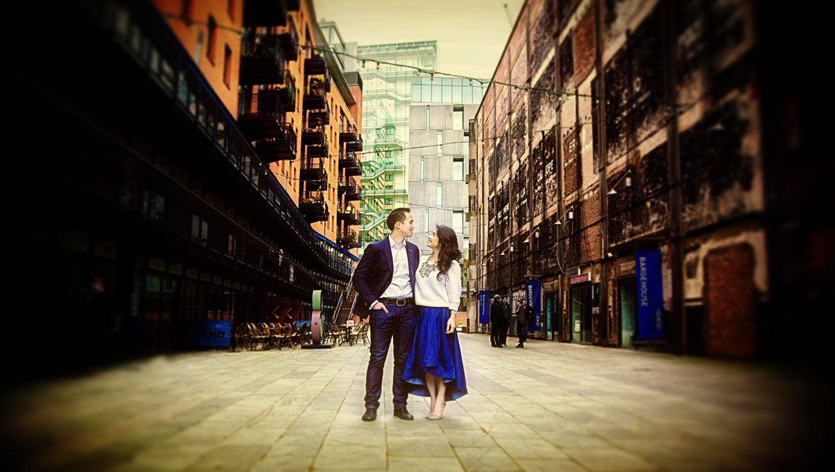 Engagement couple stood behind Oxo Tower London
