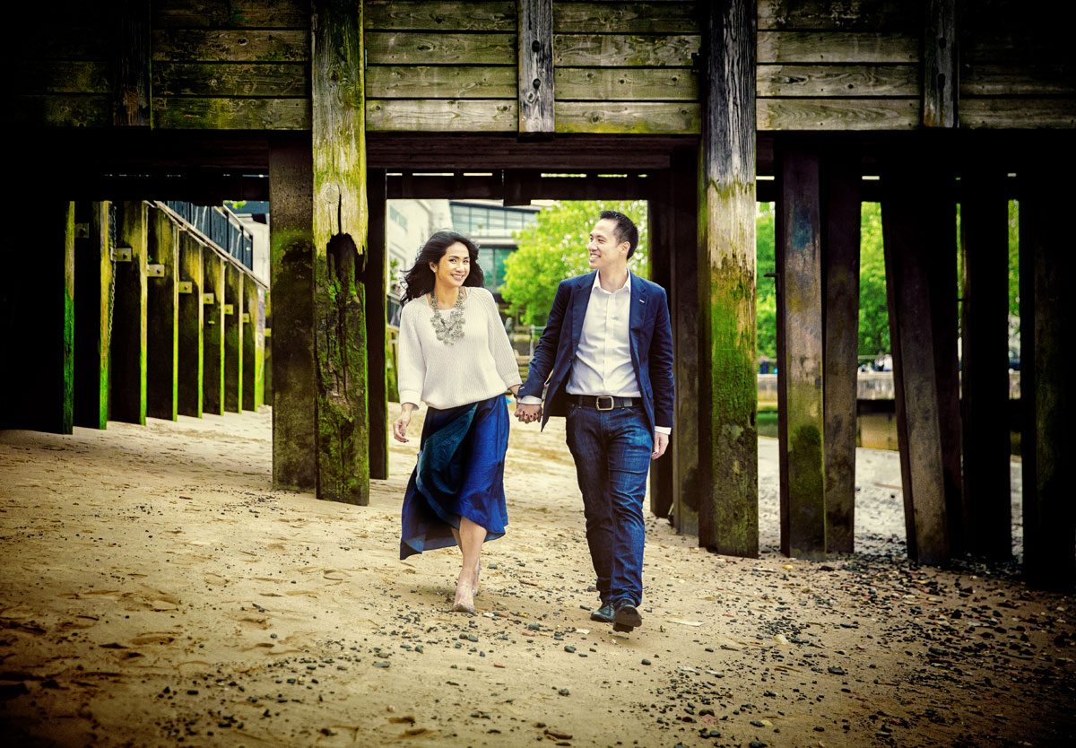 Engagement shoot couple walk on by Thames on Southbank