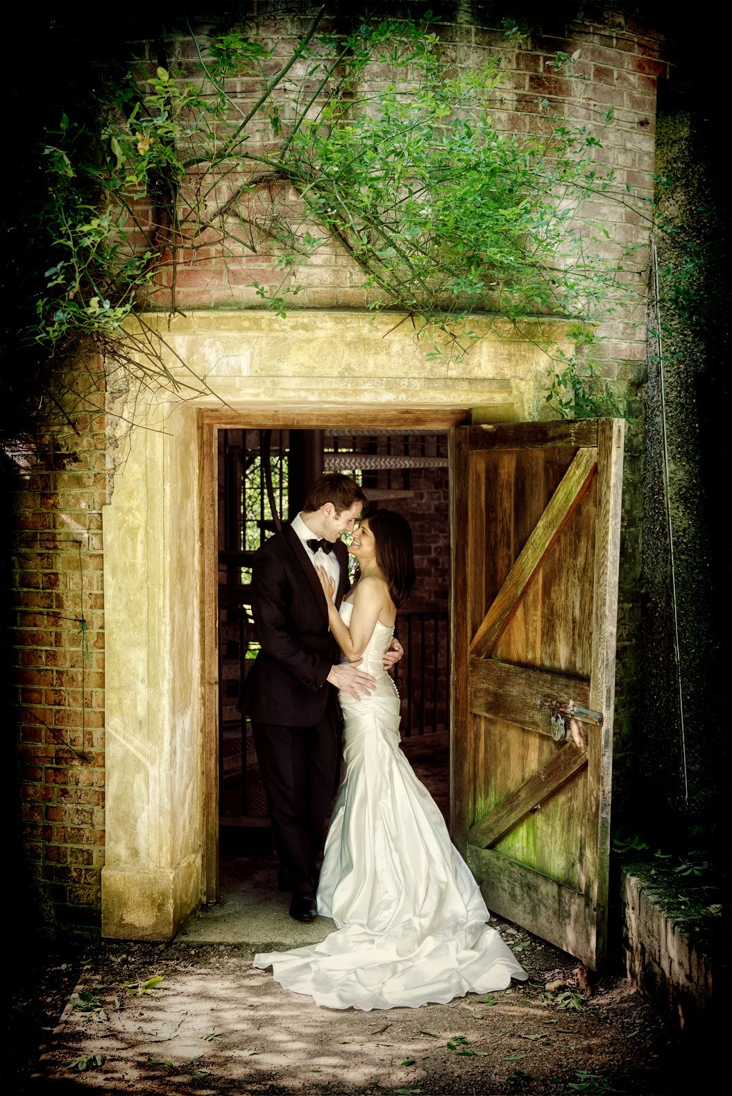 Wedding couple kiss in a doorway on their central London wedding