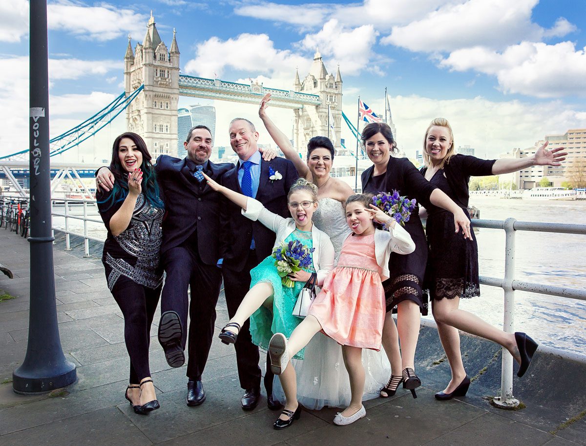 London-wedding-party-pose-by-Tower-Bridge-at-Butlers-Wharf
