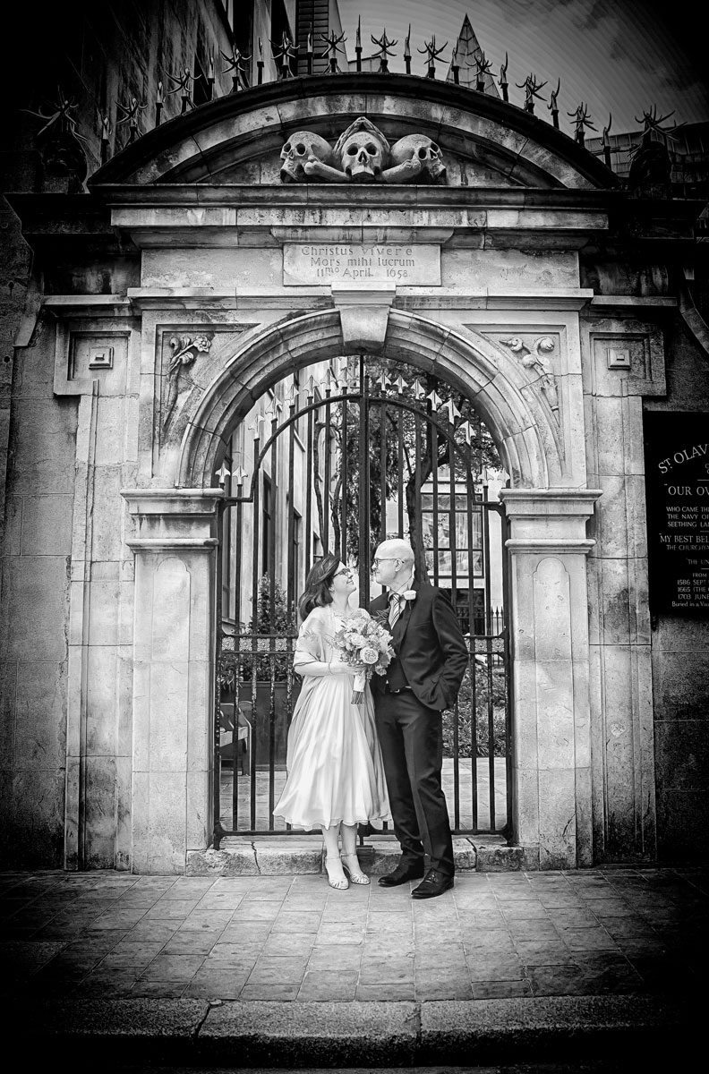 Wedding couple at the gates of St Olave Hart Street London