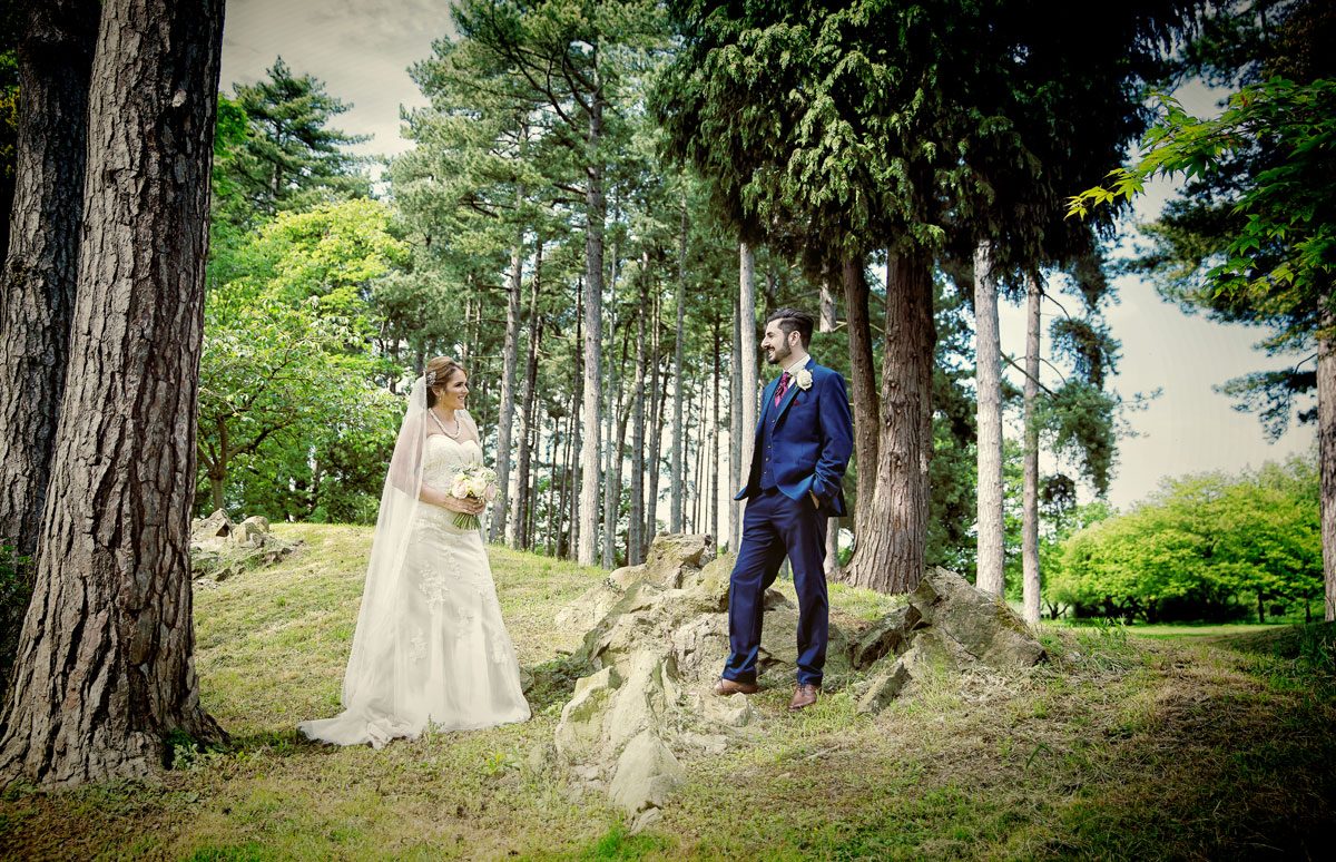 Bride and groom by trees at Fanhams Hall wedding