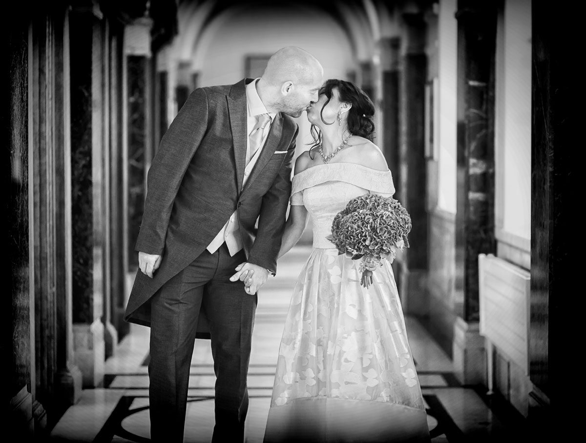 Couple kiss in corridor at their Islington Town Hall wedding