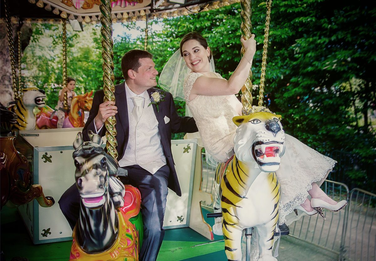 Wedding couple on carousel at London Zoo