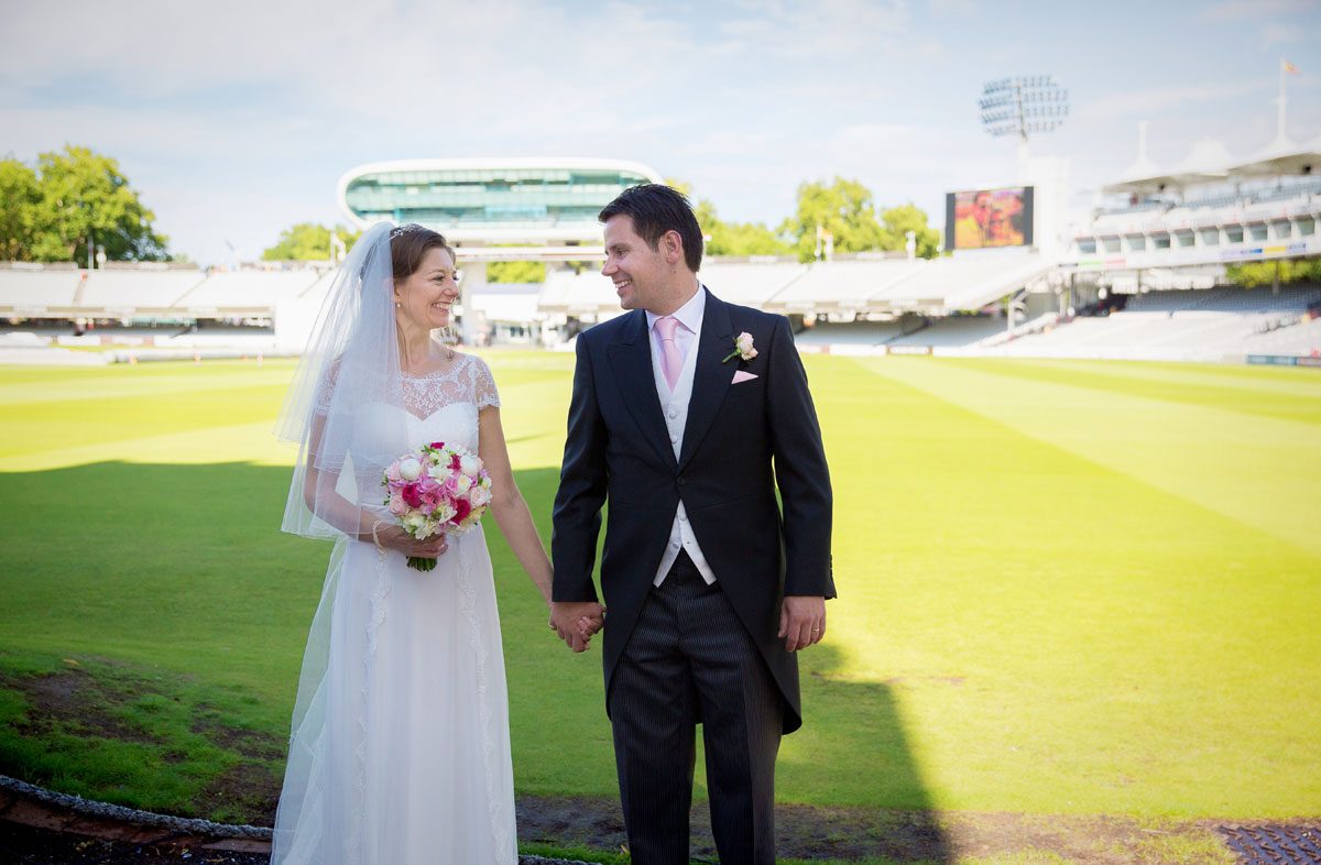 Bride and groom pitch side at Lords Cricket Ground wedding image