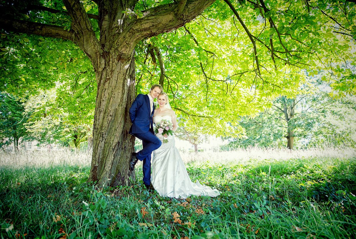 Couple pose under tree after Barnet wedding
