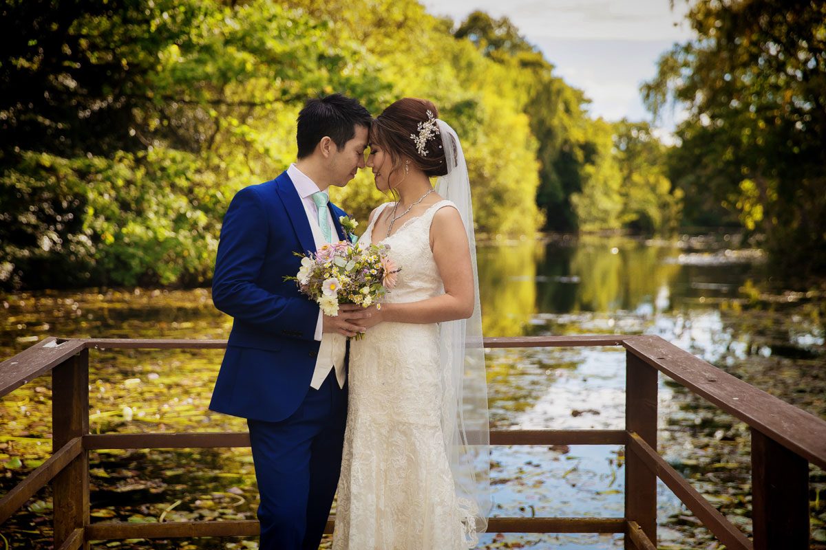 Wedding couple by lake at Stoke Place Hotel