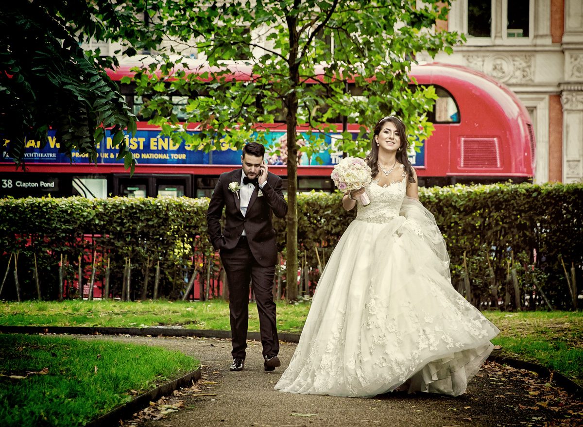Bride and groom walk through London park after Connaught Rooms wedding