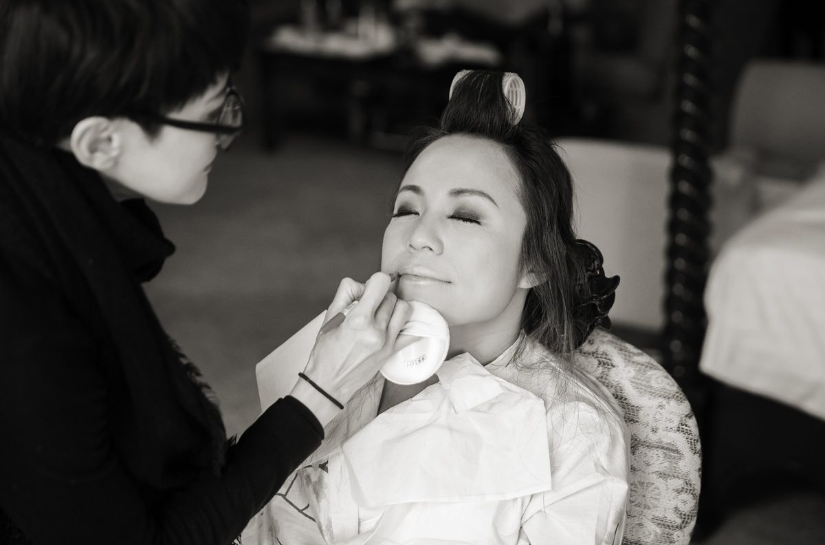 Bride getting makeup for Hanbury Manor wedding day