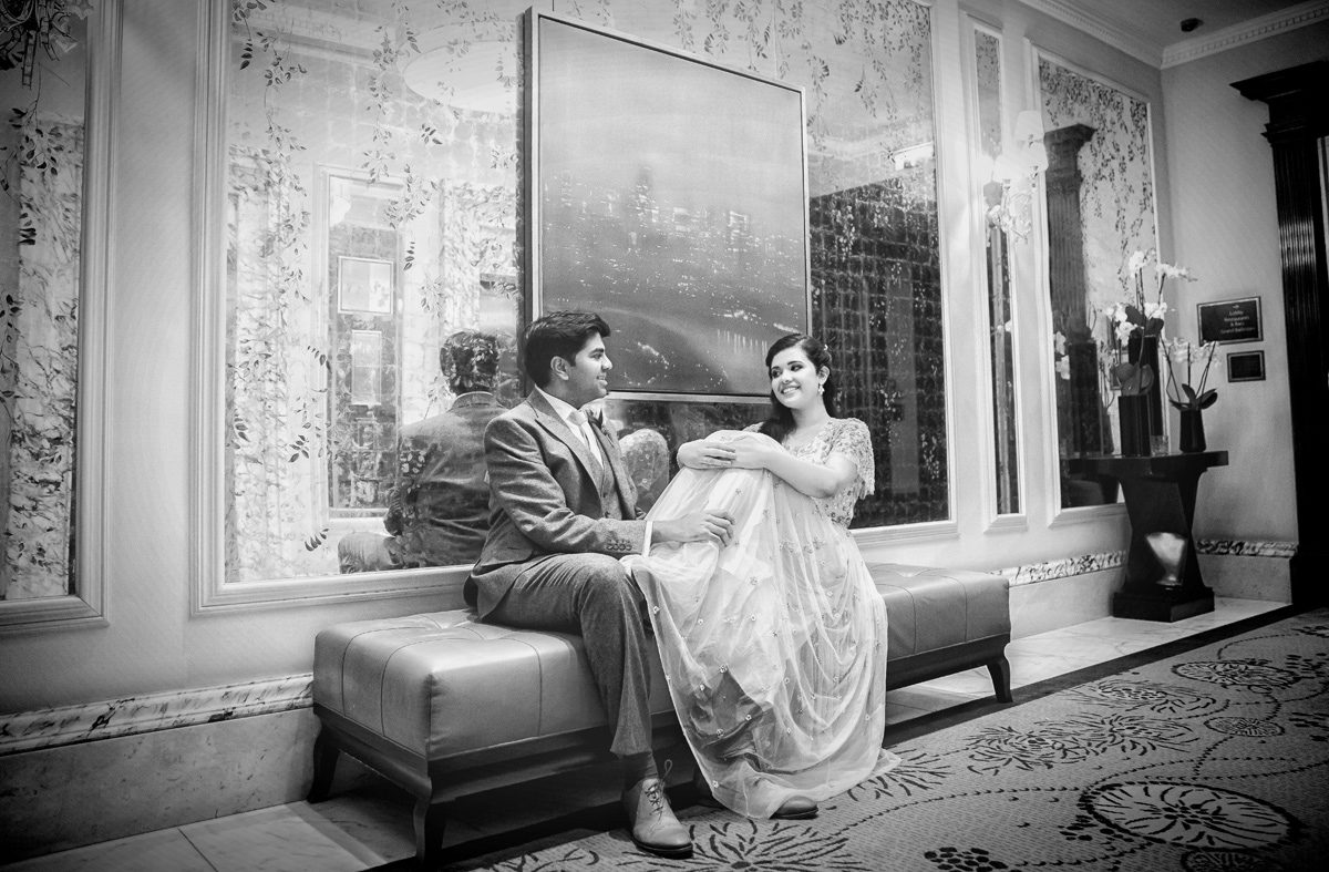 Bride and groom sitting at Langham Hotel wedding reception
