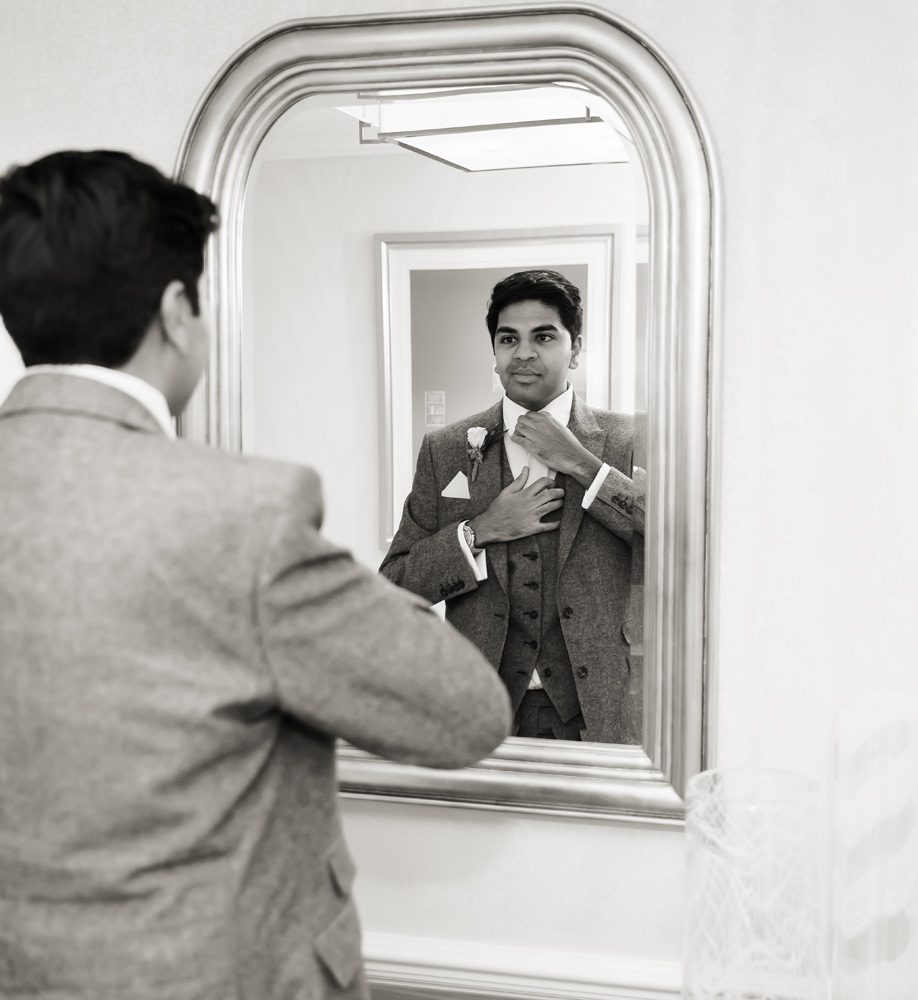 Groom in mirror at Langham Hotel London wedding