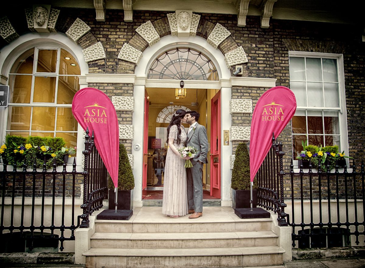 Wedding couple kiss in front of Asia House London