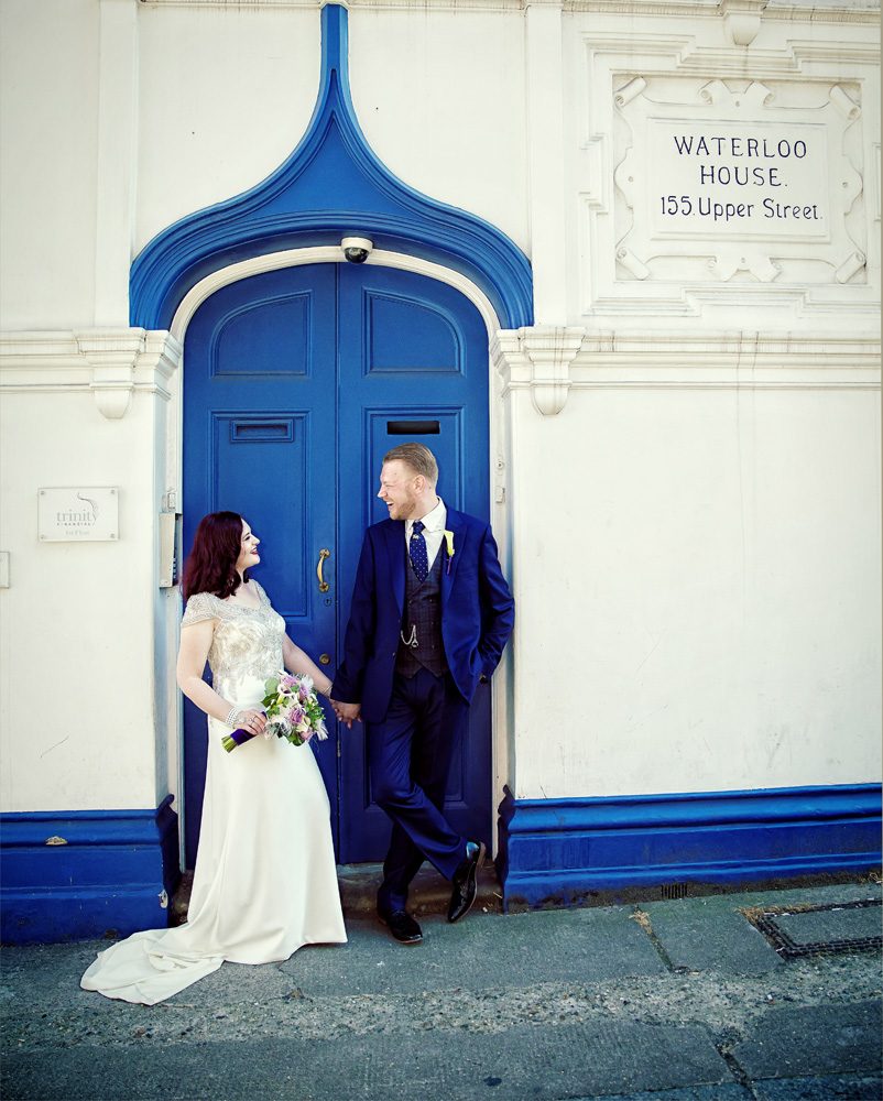 Bride and groom by blue door Islington wedding